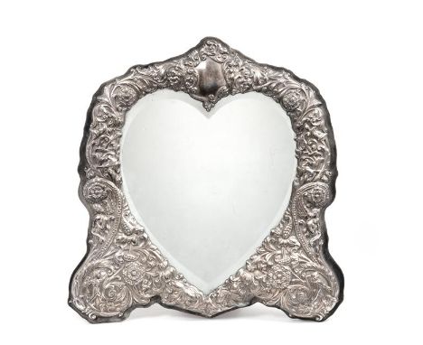 An Elizabeth II Silver-Mounted Dressing-Table Mirror, by David Shaw Silverware Ltd., London, 1989, shaped oblong and with eas