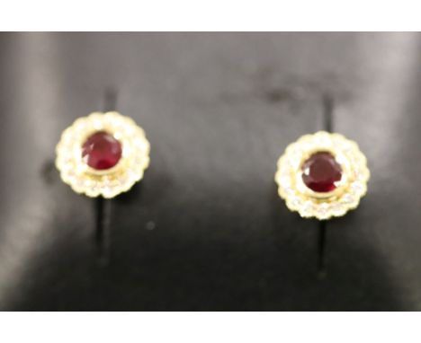 A pair of 18ct yellow gold ruby and diamond cluster earrings