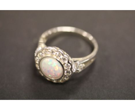 A silver CZ and opal dress ring