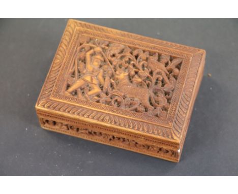 A profusely carved trinket box the lid carved with figure hunting tiger.