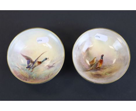 Two Royal Worcester pin dishes, both with painted images, one depicting flying ducks the other pheasants and both signed Jame