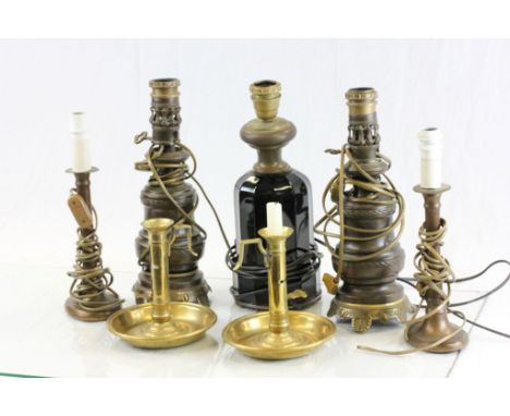 Five vintage lamp bases and a pair of brass candlesticks