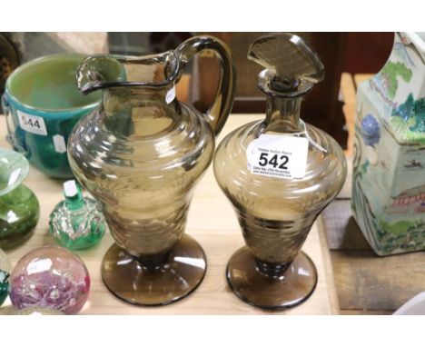 A smoked glass decanter and jug with ground out pontil marks possibly Whitefriars
