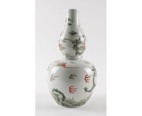 A CHINESE FAMILLE-VERTE DOUBLE GOURD VASEBlue six character Kangxi mark but later
Painted with a dragon above rocks and break