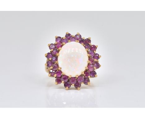 A 9CT GOLD, GARNET AND OPAL OVAL CLUSTER RINGClaw set with the oval opal at the centre within a two tier surround of circular