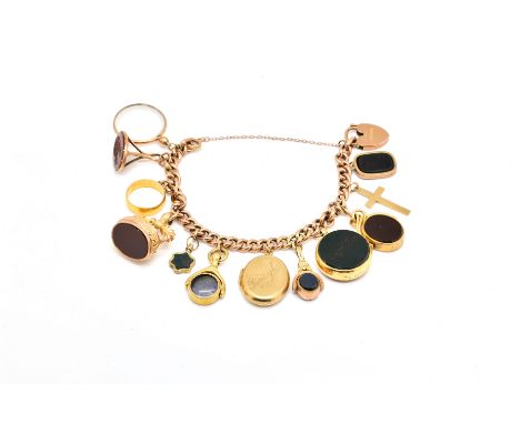 A GOLD CURB LINK CHARM BRACELETfitted with twelve seals and other pendants, to include and 18ct gold compass fob, a  22ct gol