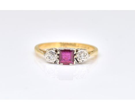 A GOLD AND PLATINUM, RUBY AND DIAMOND SET THREE STONE RINGMounted with a square cut ruby at the centre, between two circular 