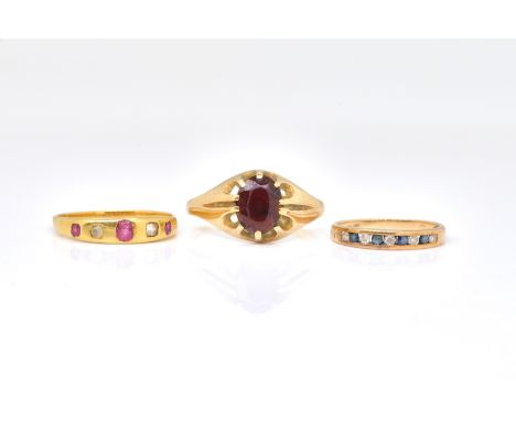 THREE RINGS (3)Comprising; a 9ct gold ring, claw set with an oval cut garnet, ring size U, gross weight 2.4 gms, a gold, diam