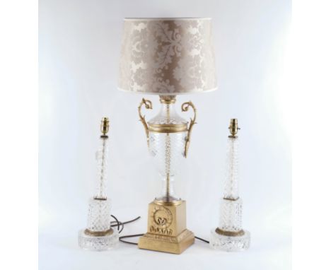 A PAIR OF CRYSTAL COLUMN TABLE LAMPS WITH GILT-METAL MOUNTS AND ANOTHER TWIN-HANDLED URN LAMP ON BASE WITH SHADE (3)The pair 