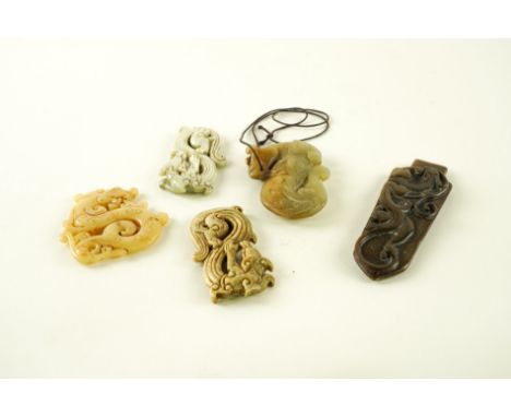 A GROUP OF SIX CHINESE ARCHAISTIC JADE CARVED DRAGON PENDANTS (6)Of various forms and colour, sizes 7cm to 12.5cm lengthOvera