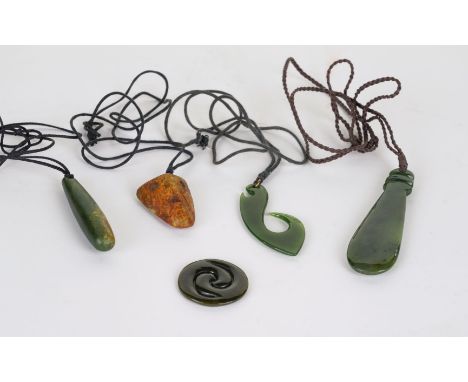 FOUR MAORI JADE PENDANTSModern
Including one shaped as a war club, 8cm length, one in the form of a hook and another in the f