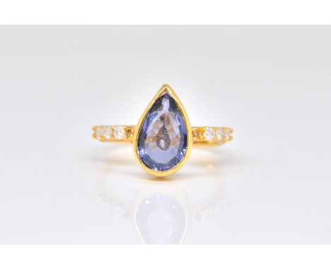 AN IOLITE AND DIAMOND RINGBezel set with a pear-shaped iolite, with diamond set shoulders, detailed 750, ring size Q, gross w