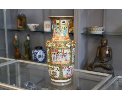 A CANTON FAMILLE-ROSE BALUSTER VASE19th century
Painted with panels of figures and panels of birds and insects amongst fruit 