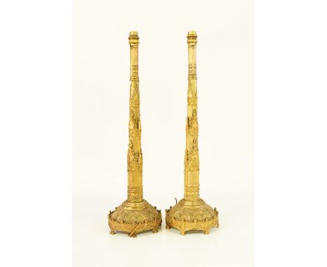 A PAIR OF EMBOSSED GILT-BRASS GOTHIC TABLE LAMPS (2)19th Century
Later converted to electricity and wired, each mounted with 