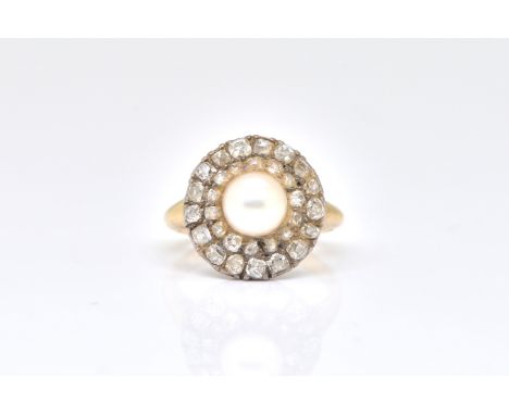 A DIAMOND AND CULTURED PEARL CLUSTER RINGLate 19th century, the centre set with a 6.5mm cultured pearl within a two-tier surr