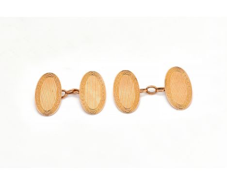 A PAIR OF 9CT GOLD CUFFLINKSThe oval backs and fronts with engine turned borders and with reeded centres, Birmingham 1925, we