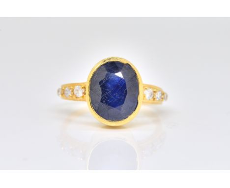 A SAPPHIRE AND DIAMOND RINGBezel set with an oval-cut sapphire, with diamond set shoulders, detailed 750, ring size T, gross 