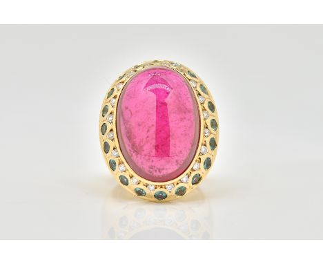 A GOLD, TOURMALINE AND DIAMOND RINGCollet set with the oval cabochon pink tourmaline in a surround of small circular cut diam