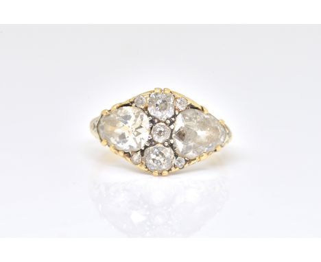 A 19TH CENTURY DIAMOND RINGClaw set with two pear-shaped diamonds and seven further diamonds, in a marquise shaped setting, w