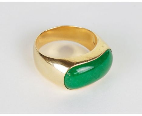 A MAN'S GOLD SADDLE RINGInset with an apple green jadeite cabochon, stamped 18k 750, 13 gms. gross weightGood condition, scra
