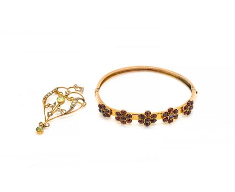 A BOHEMIAN GARNET BANGLE AND A PENDANT BROOCH (2)The oval hinged bangle applied with five graduated Bohemian garnet clusters,