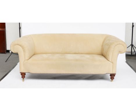 A VICTORIAN  BEIGE  SUEDE UPHOLSTERED CHESTERFIELD SOFA, ON TURNED WALNUT SUPPORTSThe back leg stamped ‘B2939’ the castors re