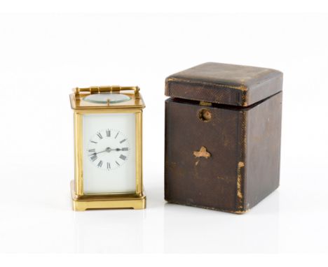 RETAILED BY TIFFANY &amp; CO. FRANCE: A BRASS CARRIAGE CLOCKEarly 20th Century 
With white dial and Roman hours, the two trai