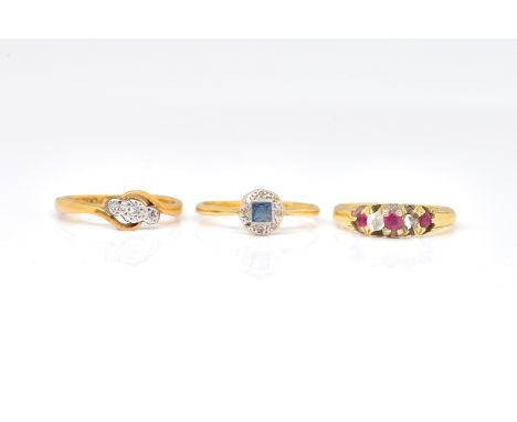 THREE GOLD AND GEM SET RINGS (3)Comprising; a gold, diamond, ruby and red gem set ring, (one diamond lacking) ring size M and