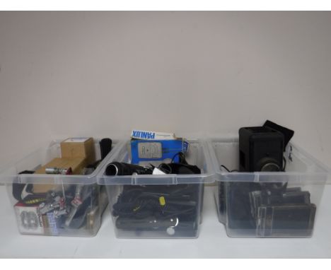 Three boxes containing various camera accessories, flash lights, developing equipment etc. (Q)