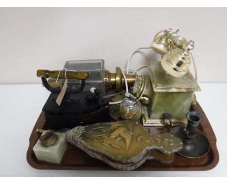 A tray of brass embossed bellows, onyx telephone, antique brass carriage lamp, flat iron, candle sconce etc 