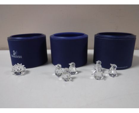 Three boxed Swarovski Crystal animals - hedgehog and two x 3 penguins on ice bergs 