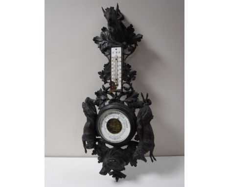 A Black Forest carved oak barometer