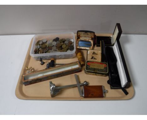 A tray containing a collection of foreign coinage, cased cufflinks, boxed Ronson lighter, desk stand, hip flask etc