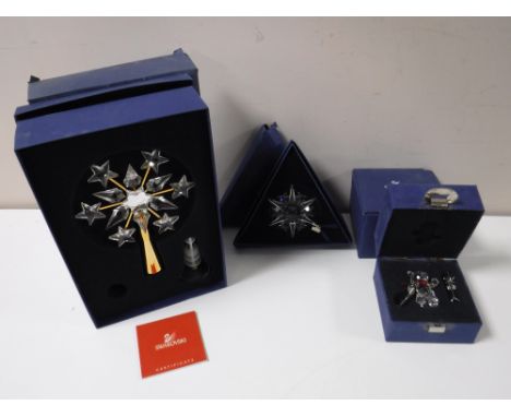 Three boxed Swarovski Crystal Christmas decorations - star, Christmas tree topper and a skiing bear 