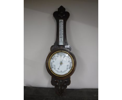 A carved oak cased barometer 