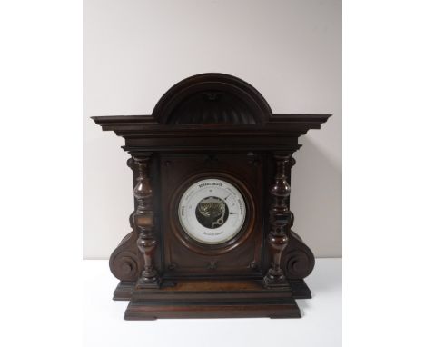 A Victorian aneroid barometer in carved mahogany case. 