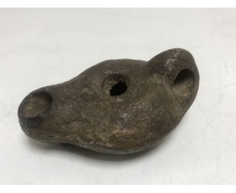 A Roman pottery oil lamp, Capri 2nd-3rd century AD, length 8 cm.