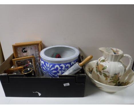 Two boxes containing blue and white planter, dolls in display cases, kitchenalia, glassware, oil lamps, early 20th century po
