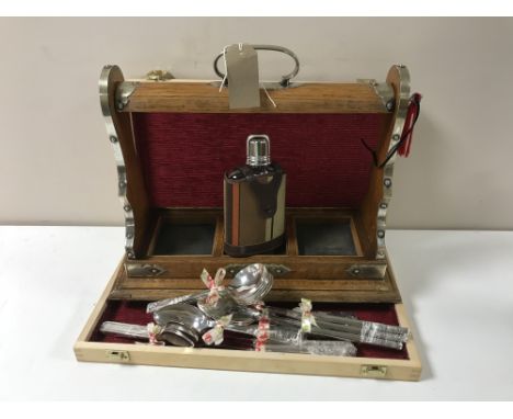 An oak three bottle Tantalus with key (no decanters), together with a hip flask and a wooden box containing cutlery CONDITION