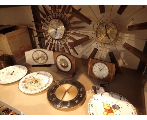 Shelf of nine clocks including Wedgwood and Royal Albert 