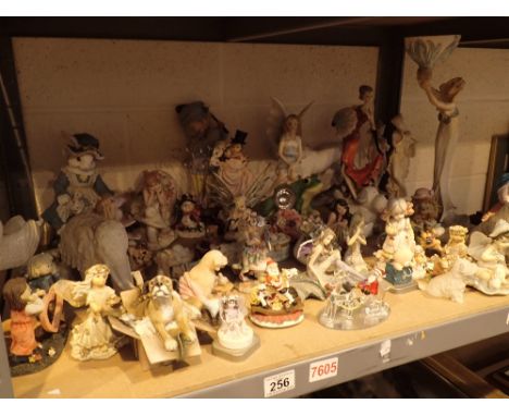 Shelf of resin figurines fairies animals etc 