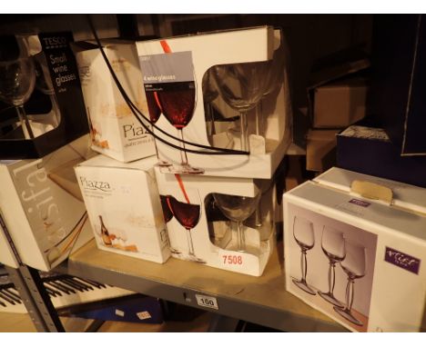 Shelf of mainly boxed drinking glasses 