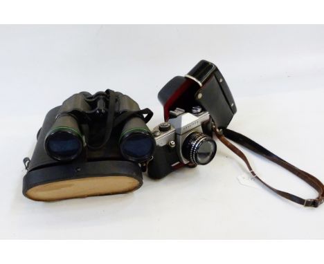 Praktica SLR camera in leather case, a pair of early 20th century binoculars retailed by Shoolbred & Co, various other binocu