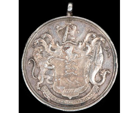 A small silver medal "To the South Devon Militia in Testimony of Merit 1799", obverse trophy of arms within wreath surrounded