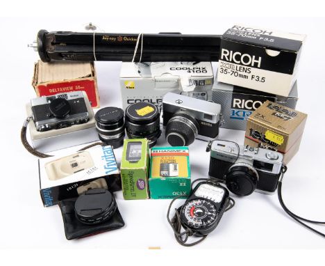 A box of cameras and accessories. Including; an Olympus Trip 35 camera with instructions. A Rollei B35 micro camera with box 