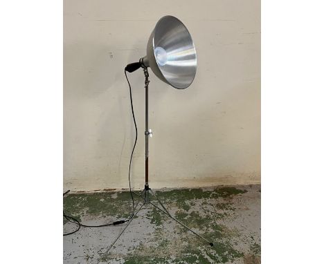 An industrial tripod floor lamp 