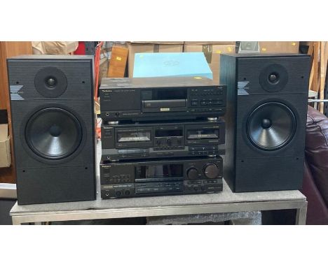 A Technics stereo system. Dual cassette, compact disc player and KEF K series speakers