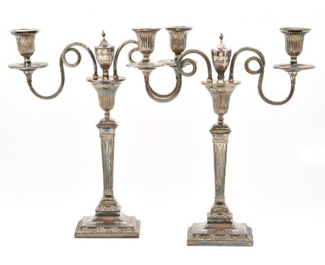 A pair of Old Sheffield plate candelabra, late 18th century, of two lights with looped and reeded branches and urn finials, o