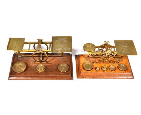 Two Victorian brass postal balances, S Mordan &amp; Co, London, late 19th c, on light or stained moulded oak base, &nbsp;21.5
