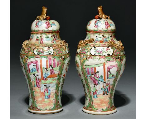 A pair of Canton famille rose inverted baluster vases and covers, mid 19th century, with gilt dog of Fo finial and applied gi